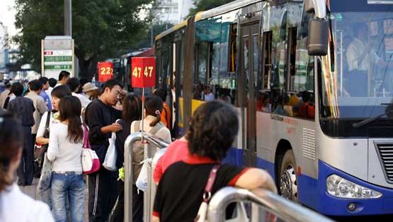 Ihmisiä bussipysäkillä Pekingissä.